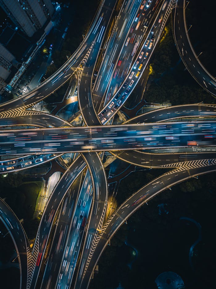 Aerial view of illuminated highways in Shanghai at night, showcasing vibrant traffic flow.